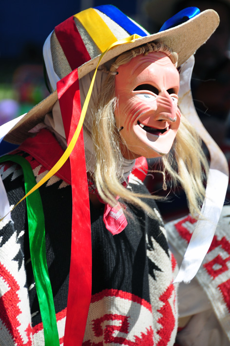 a blonde mask on top of a colorful dress