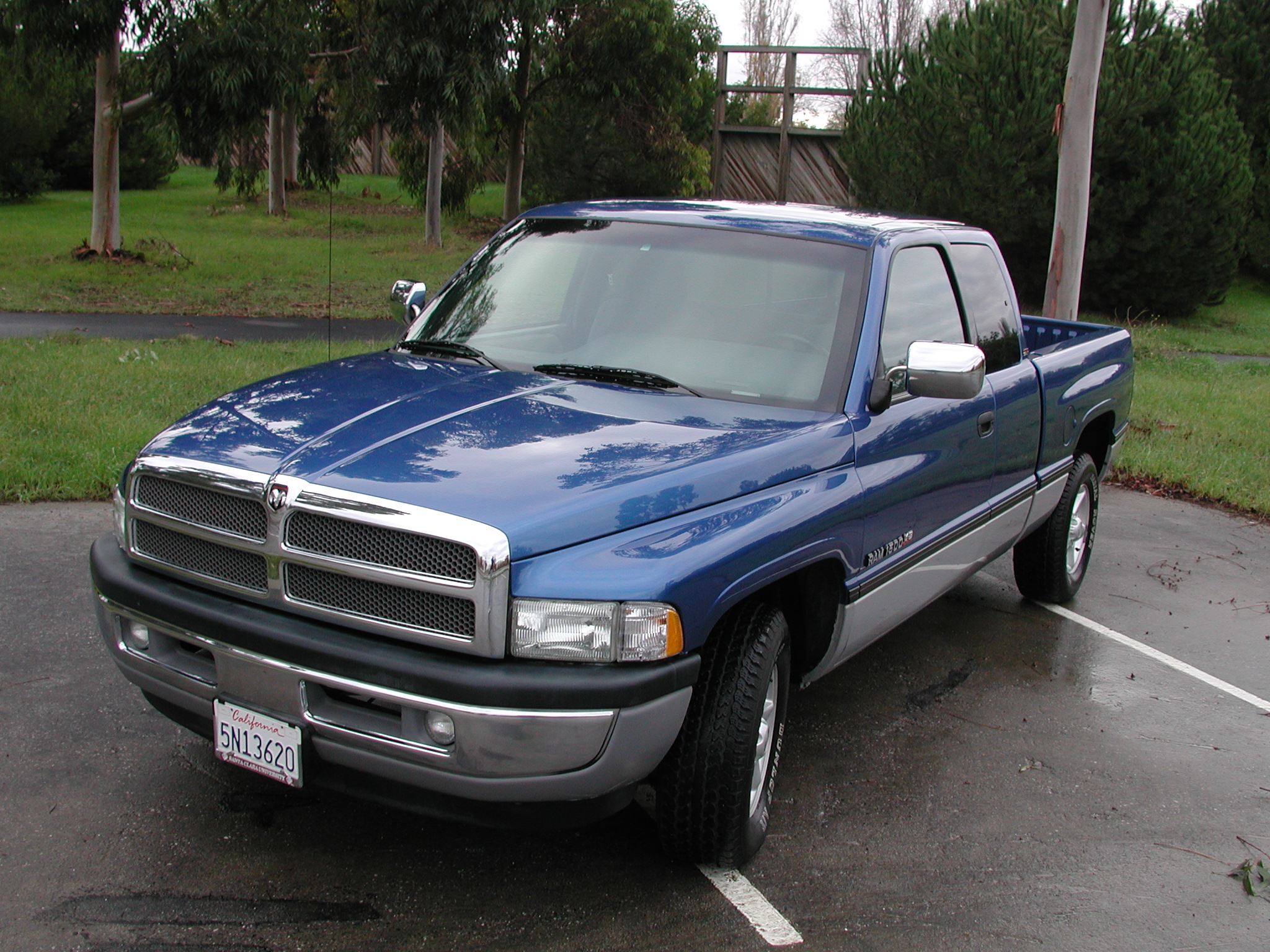 a blue dodge ram truck parked in a parking lot