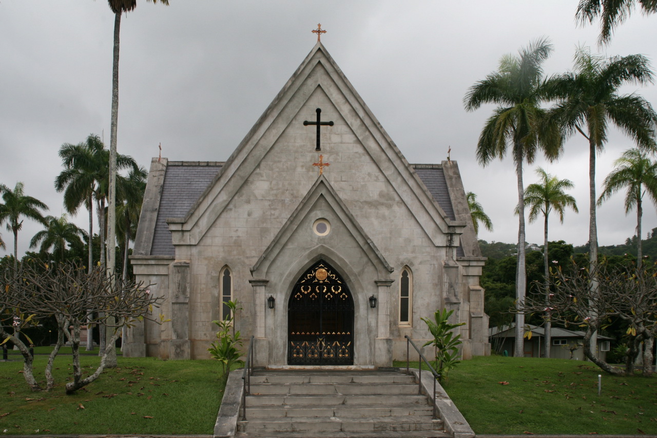 an old church with palm trees around it