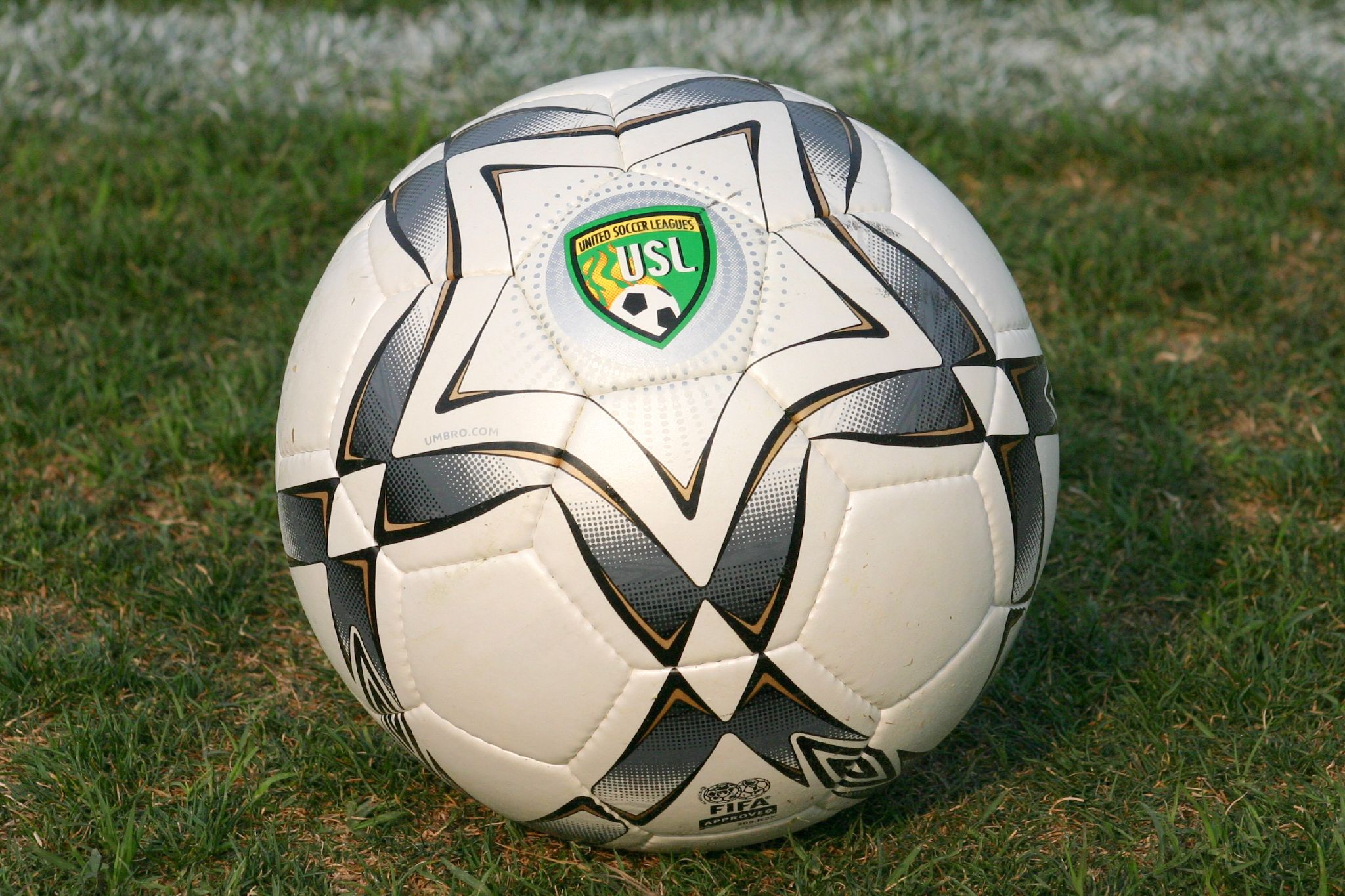 a soccer ball on a field with a green and white logo