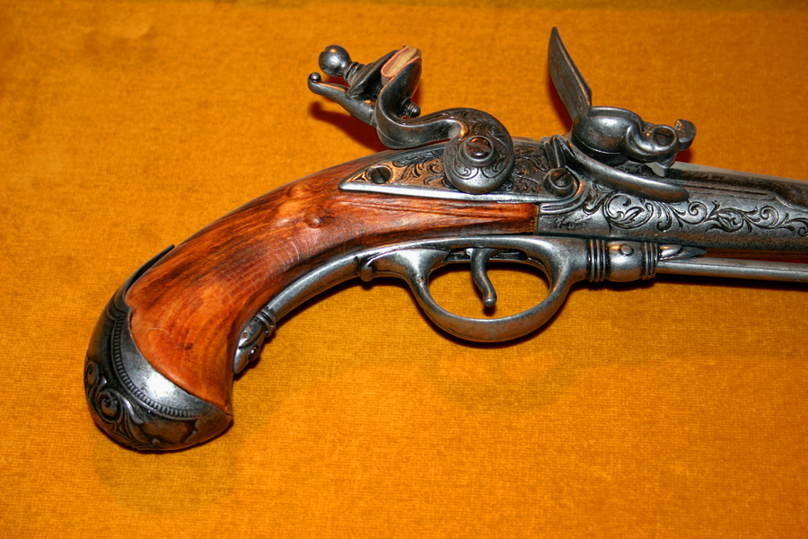 a old colt colt gun on display on an orange background