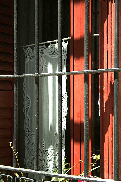 a barred window is next to the shutter
