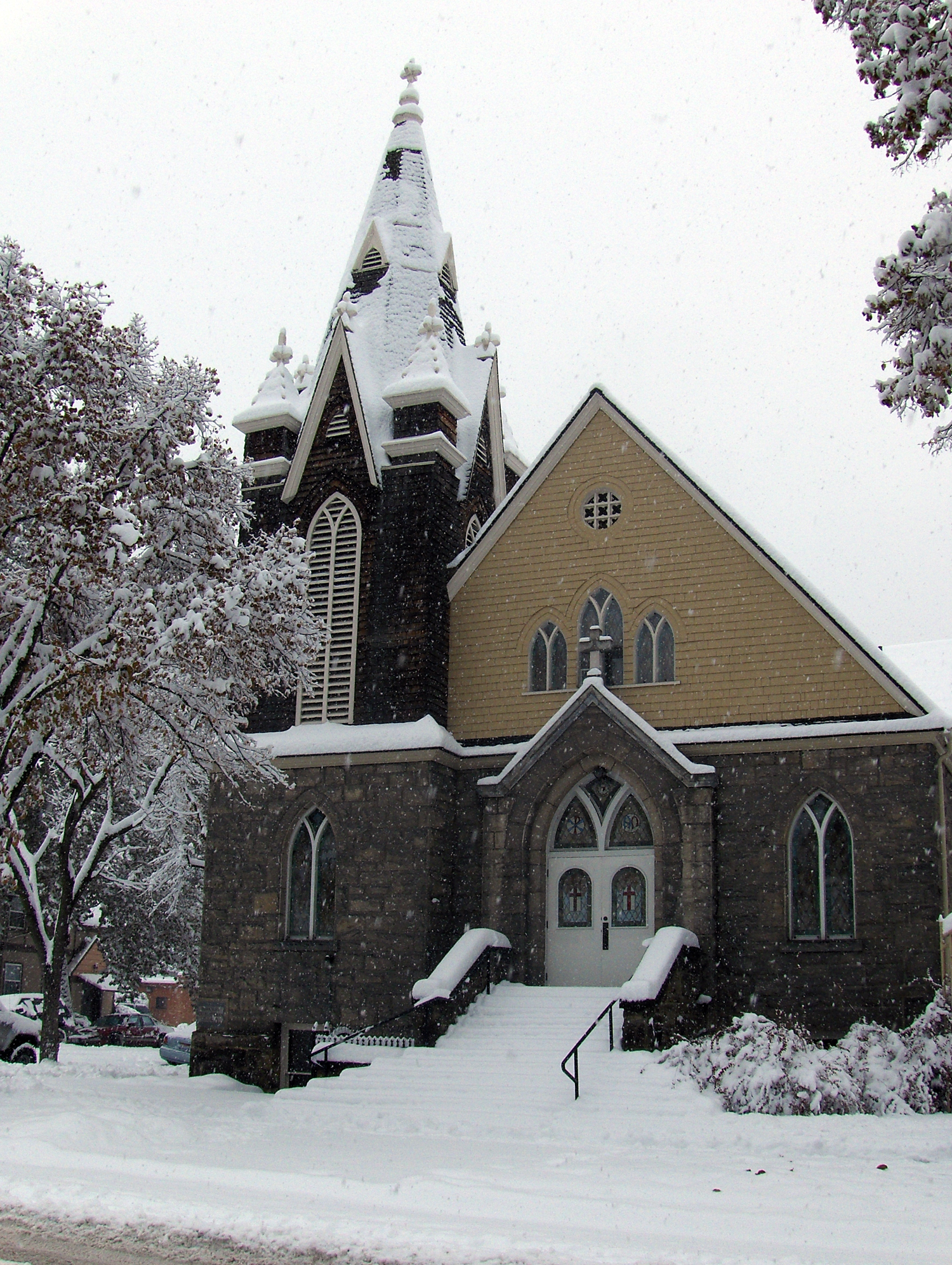 a snowy view of a church with some snow falling