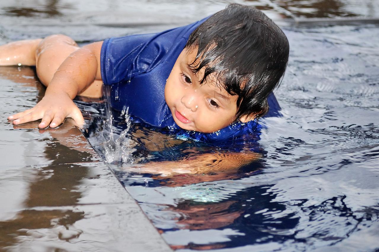 a young child on a boogie board swimming