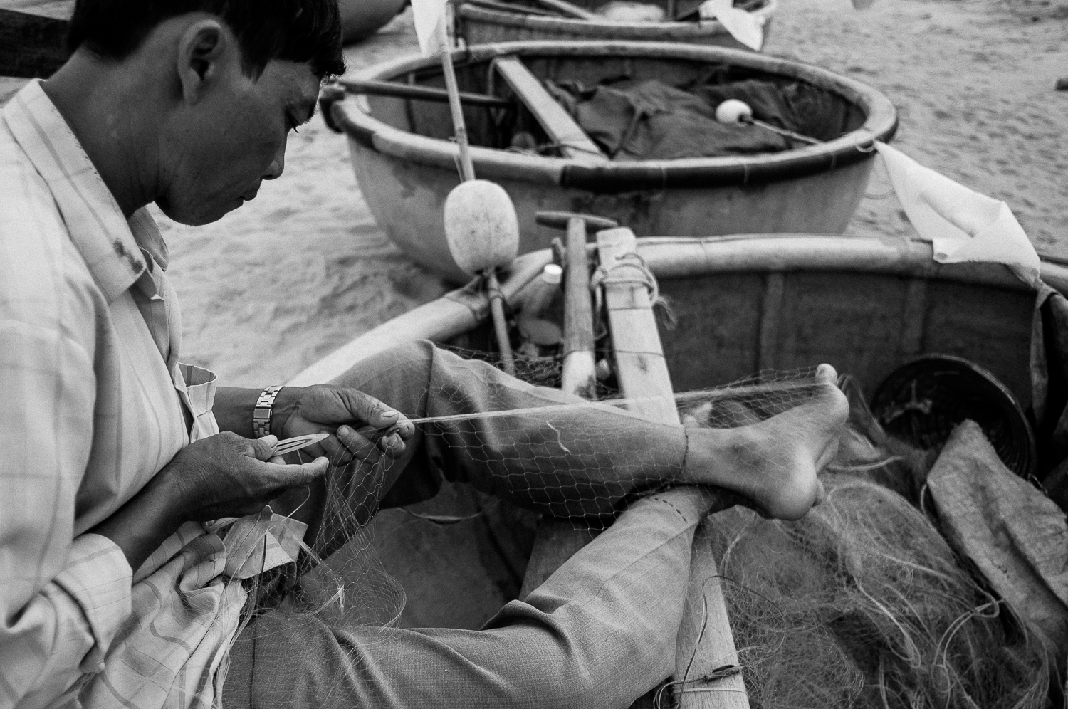 a man wearing glasses on his feet working on soing