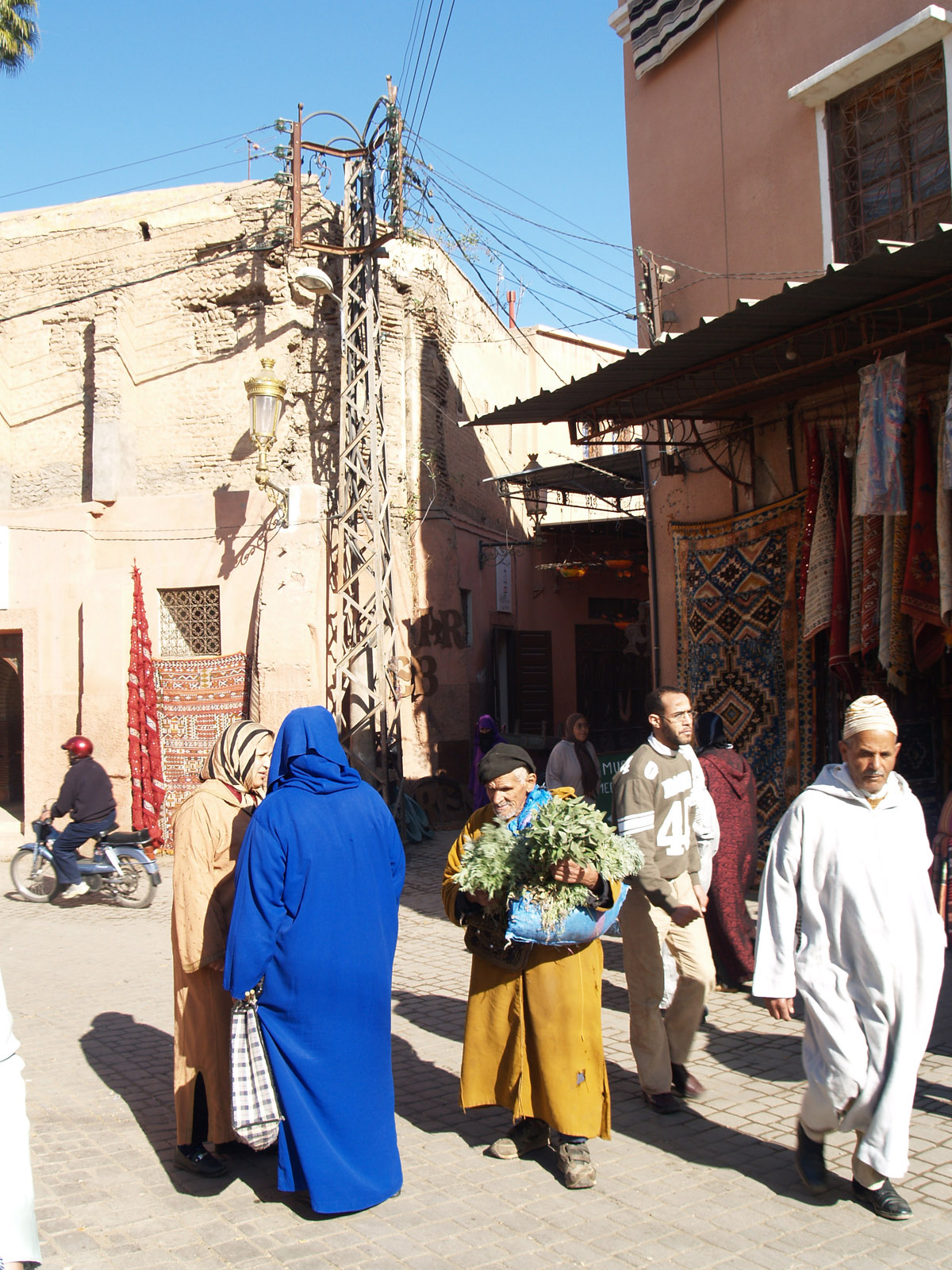 some people and a boy in blue walking