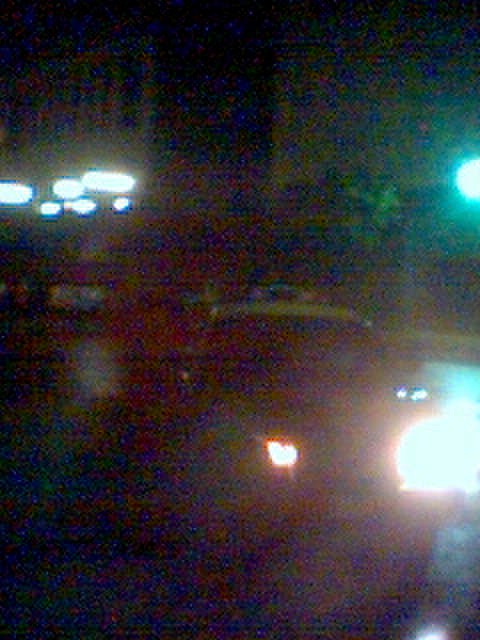 a blurry pograph shows traffic and a green light