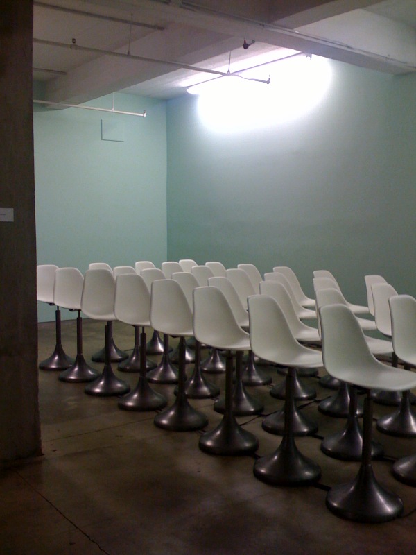 chairs lined up in a room waiting for someone to sit there