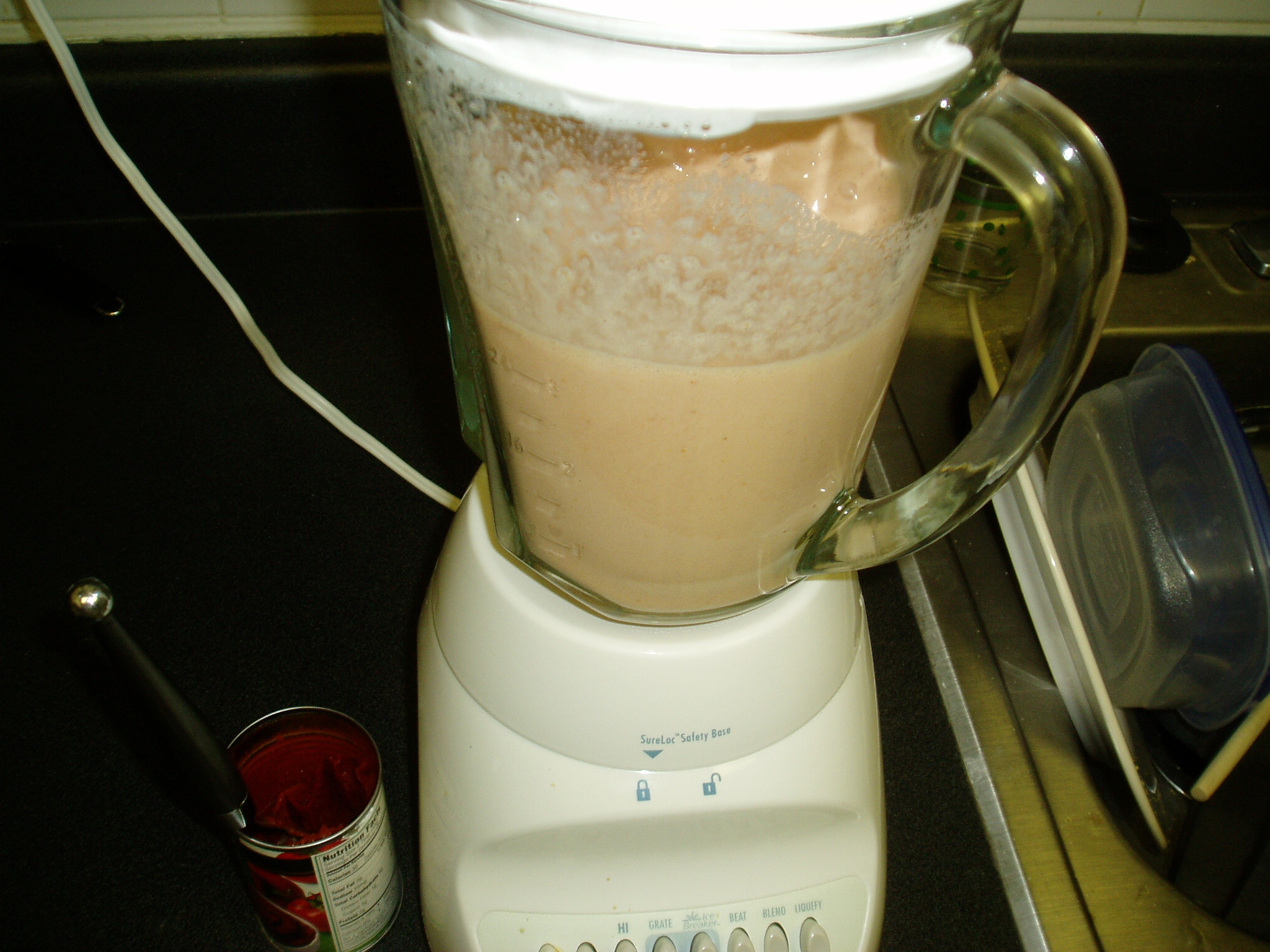 a blender on top of a counter has a white liquid in it