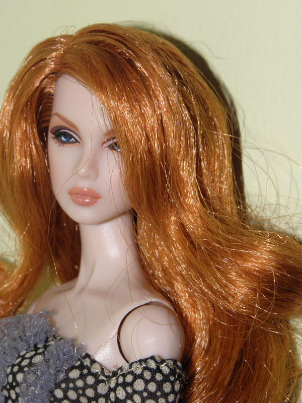 a close up po of an orange haired doll