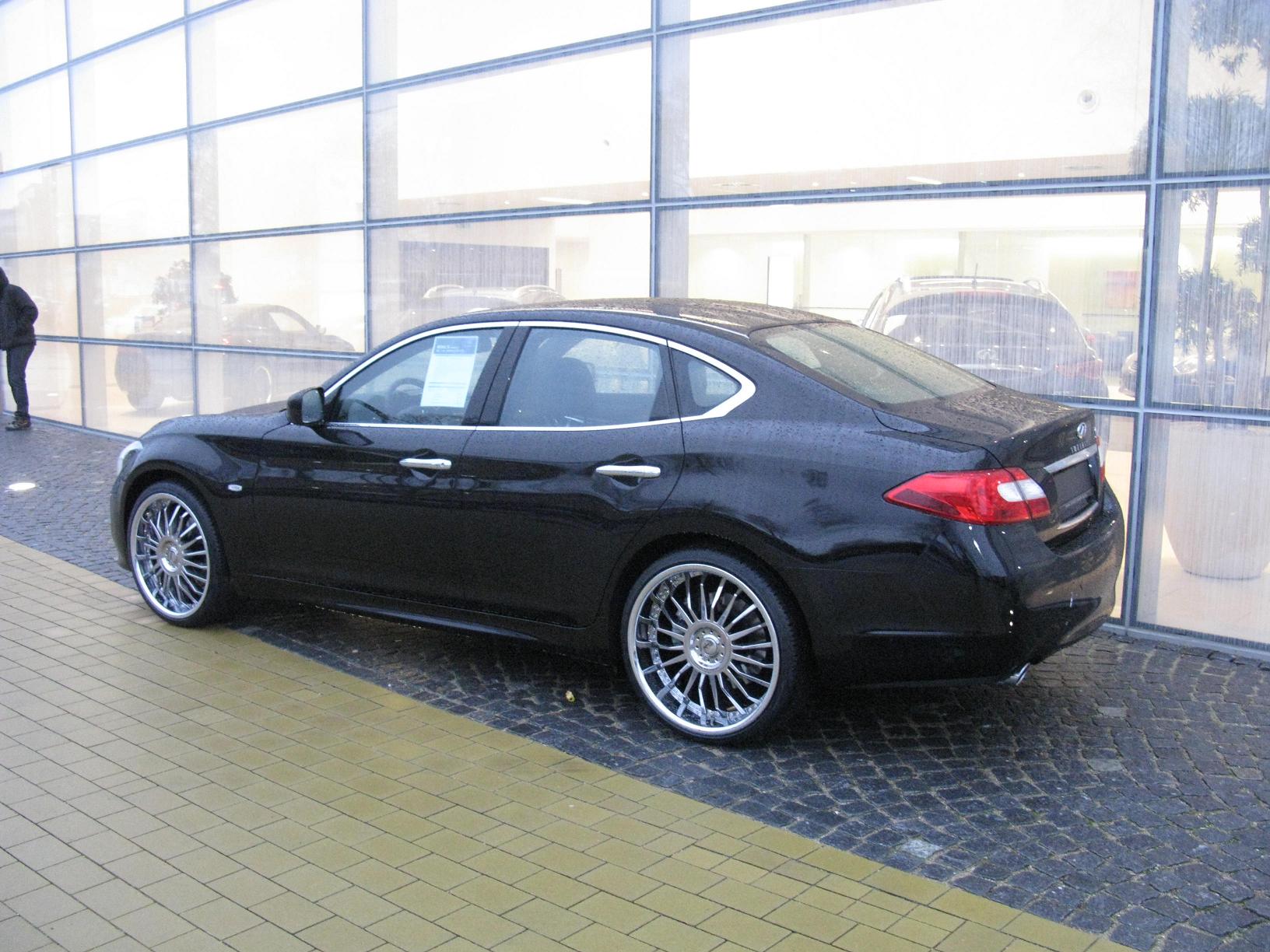 a black car parked near some glass windows