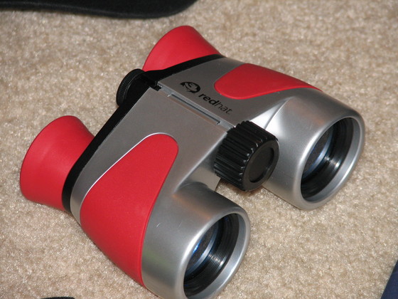 the small binoculars has a camera attached to it