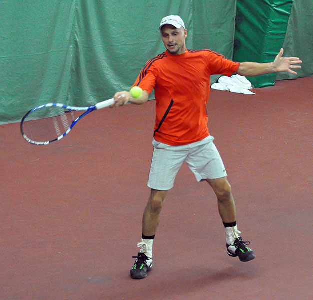 a tennis player is taking a swing at a ball