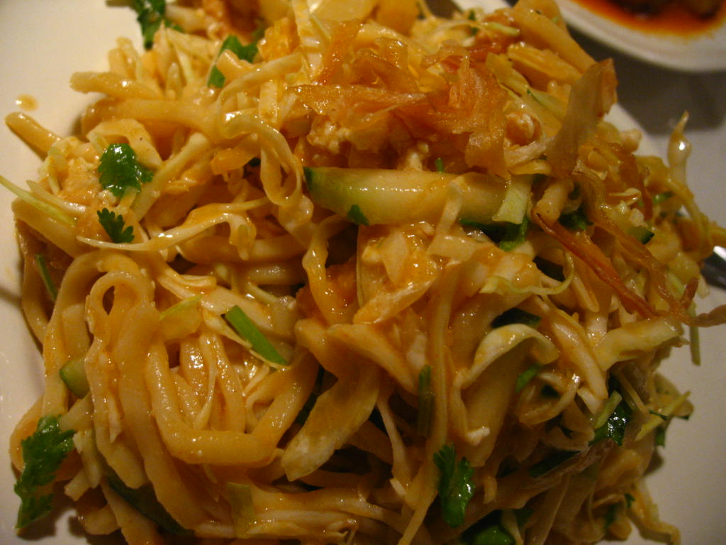 a plate of noodles on a table with sauce