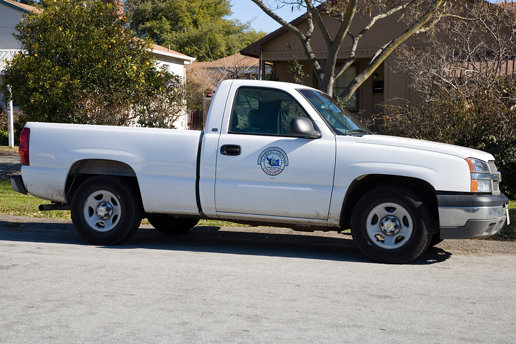 white pickup truck parked on a residential street