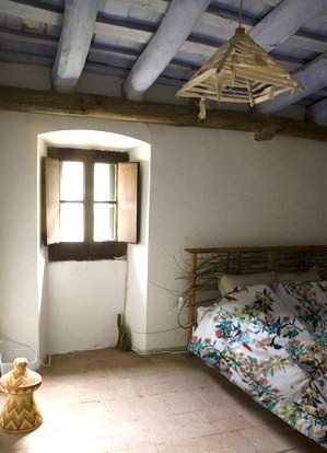 a bed room with a bed next to a window