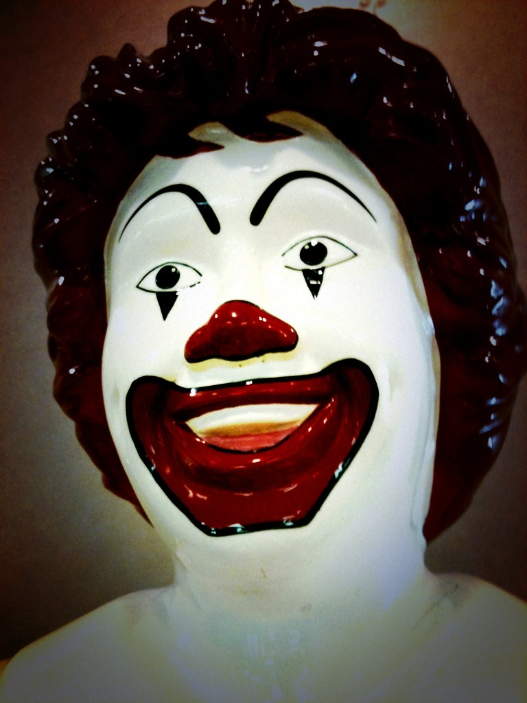 a plastic creepy clown mask with large black eyes