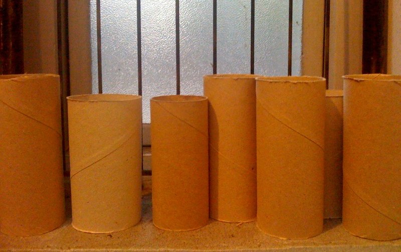 some rolls of paper laid out on a shelf
