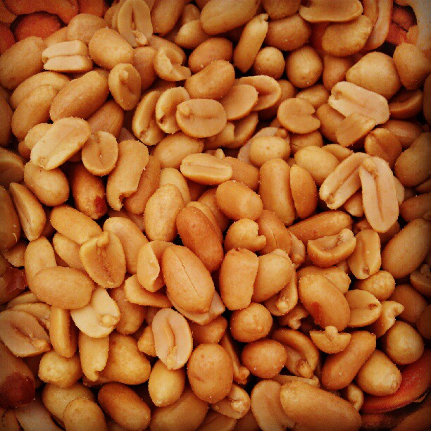 nuts and cashews are piled into a bowl