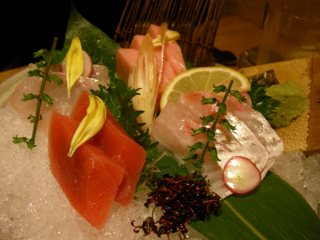 sashimi in ice, lemon, and garnish on top