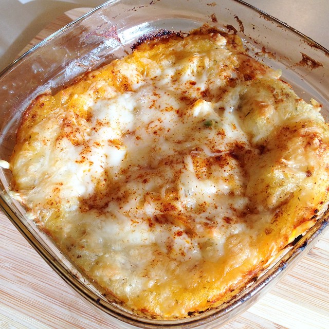 cheese covered casserole dish sitting in an oven