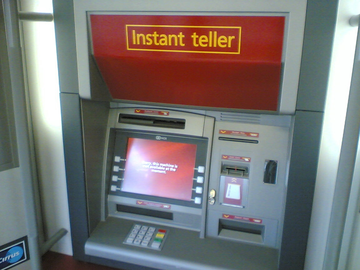 an old style atm machine with the cash register attached