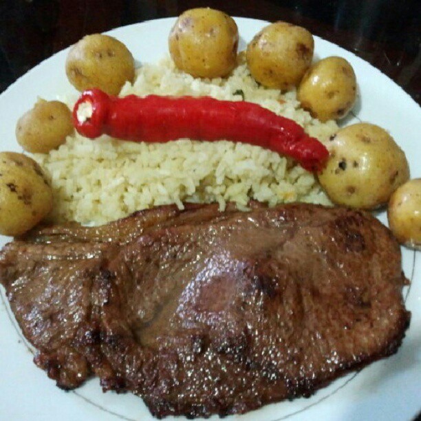 a close up of a plate of food with meat and potatoes