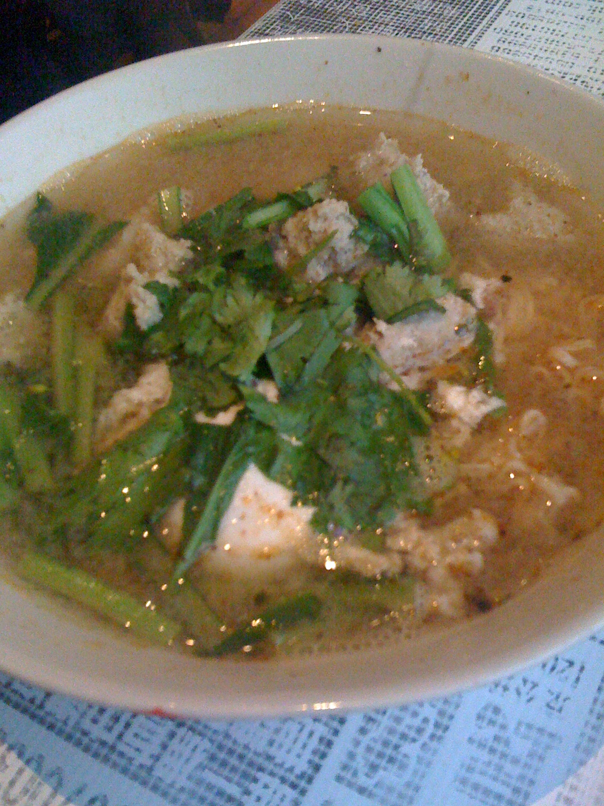 a soup bowl with chicken, green onion and peppers