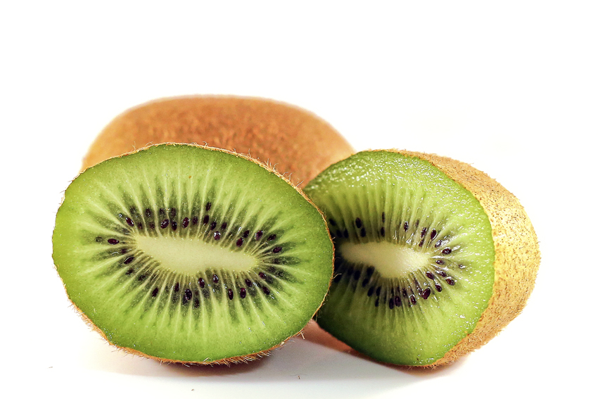 a kiwi cut in half sitting on top of a table