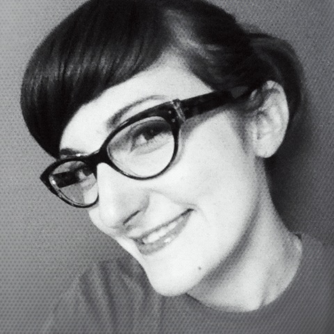 a woman in glasses posing for a black and white po