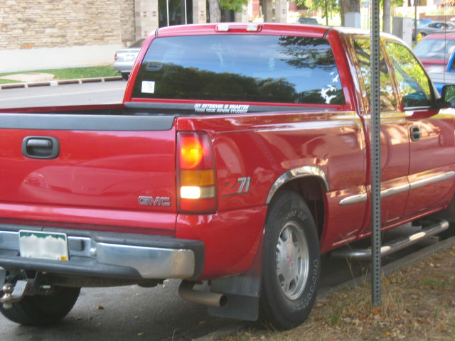 a red truck is parked along a street
