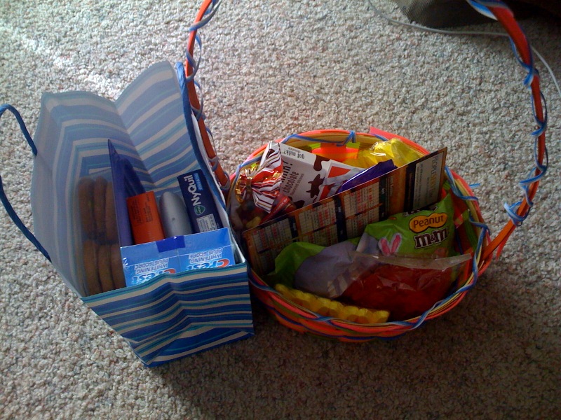 a variety of snacks sit in an empty bag on the floor