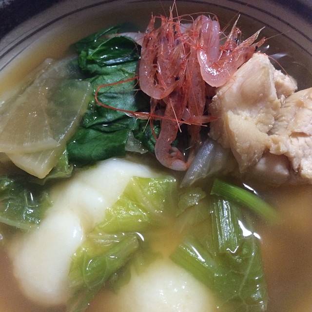 a bowl of food that includes meat, broth and greens