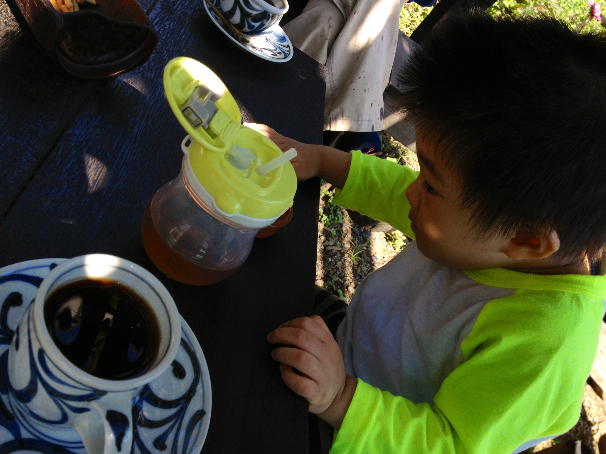 there is a little boy playing with some liquid