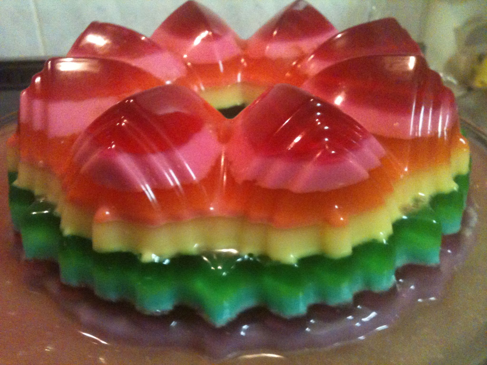 this colorful cake is topped with plastic candy