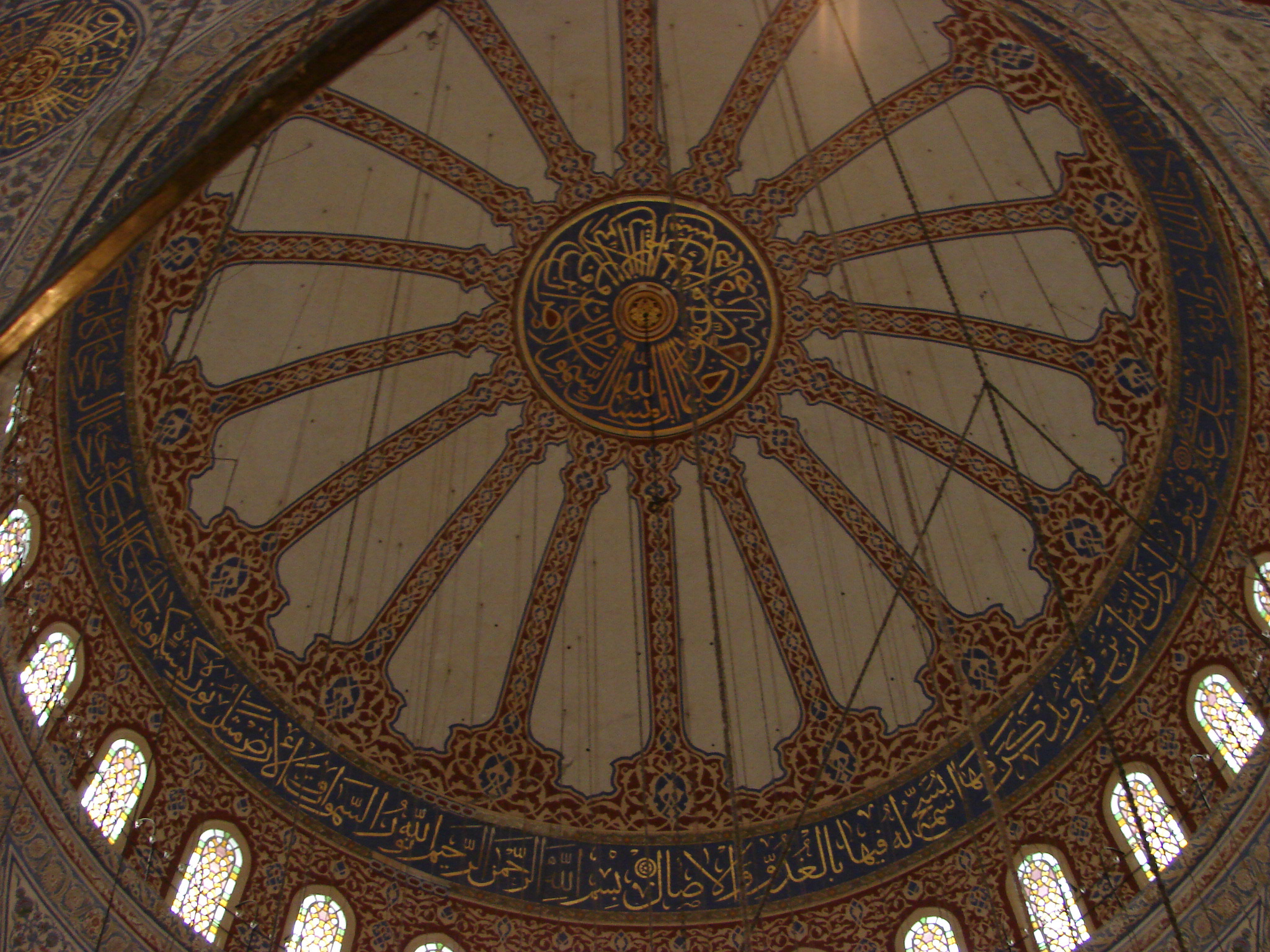 an ornate ceiling in a large building with several windows