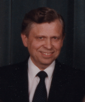 an older man smiling at the camera