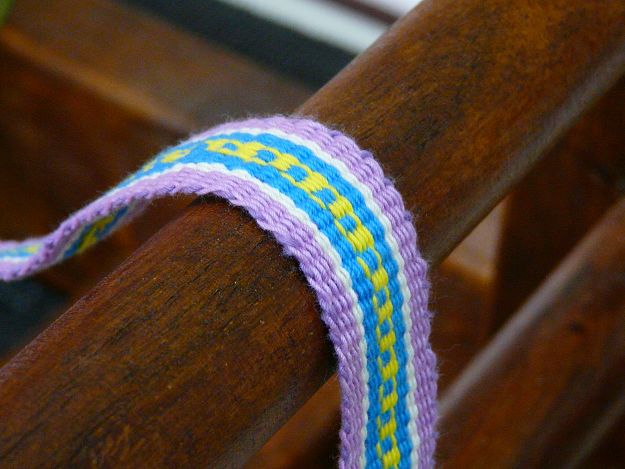 purple ribbon with a blue and yellow center