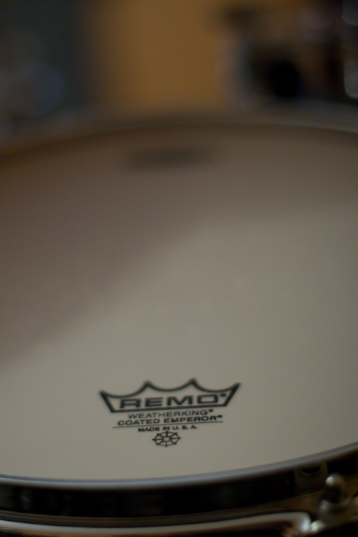 a close up of a white drum head with the company logo on it