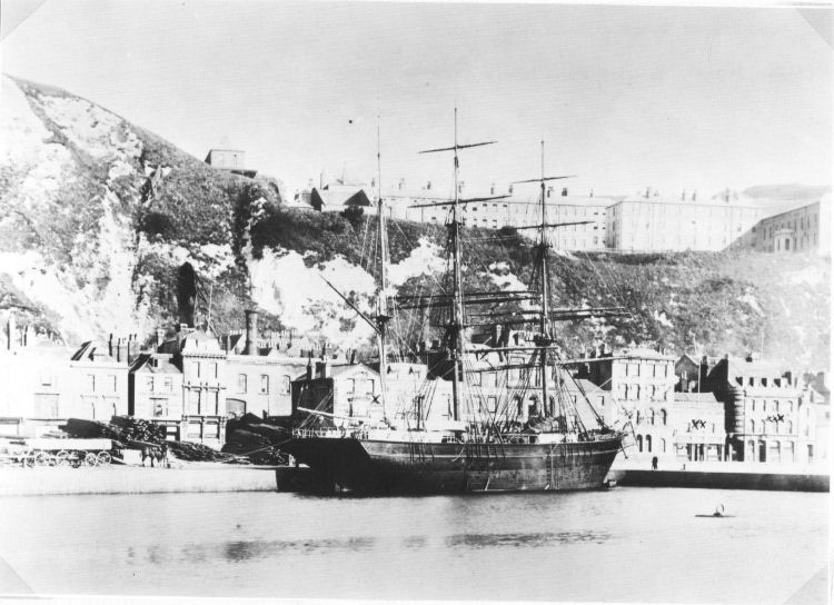 a black and white image of a ship moored