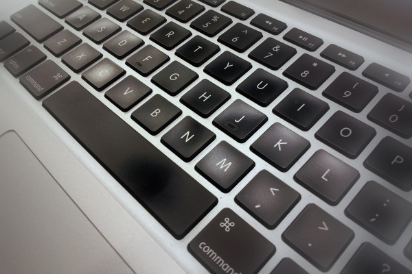an apple keyboard sitting open with the keys highlighted