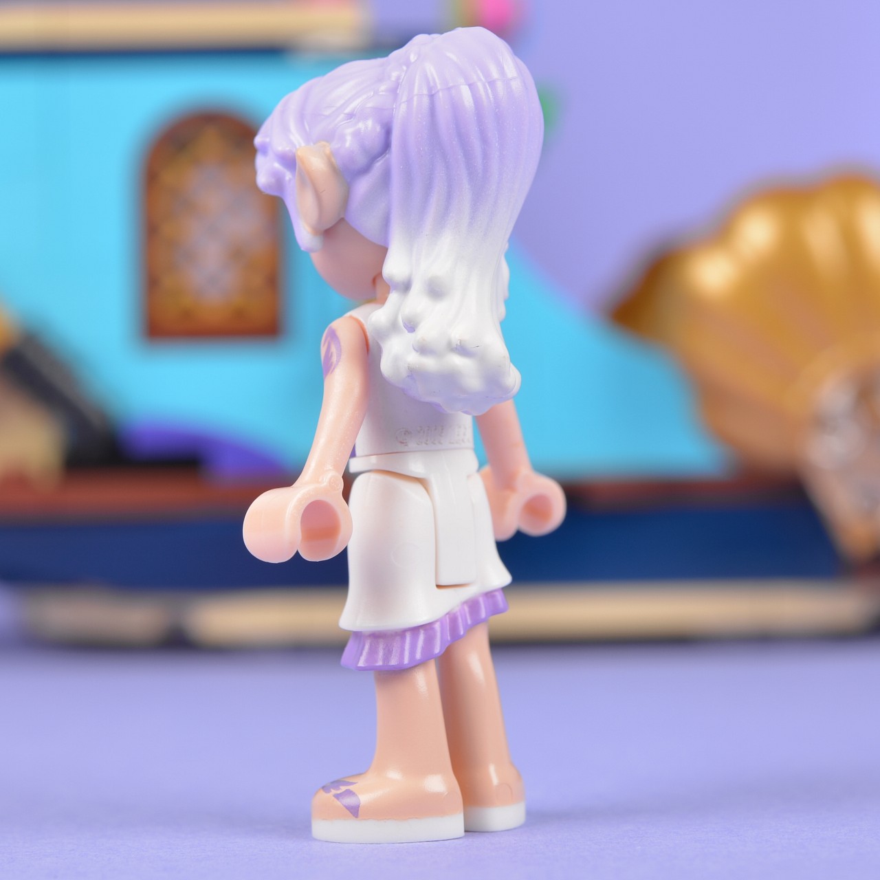 a small doll with a very small dress on