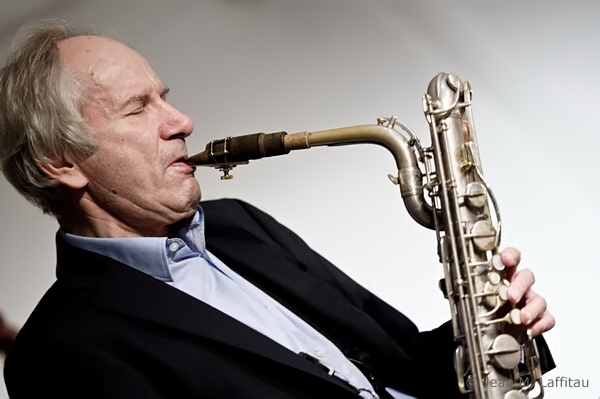 a man holding a saxophone up to his mouth