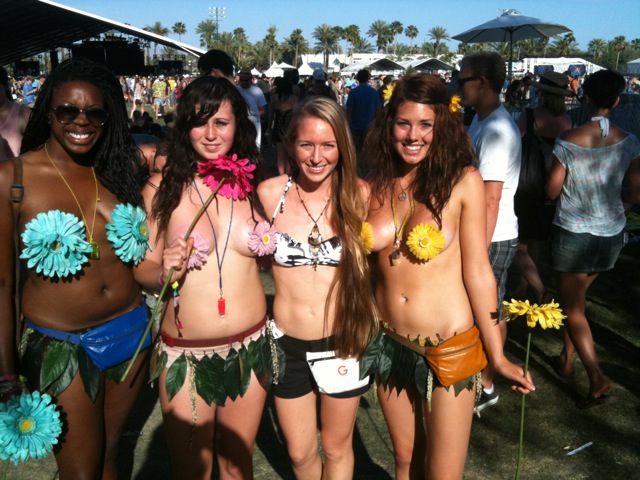 some bikini clad girls at a festival with decorations