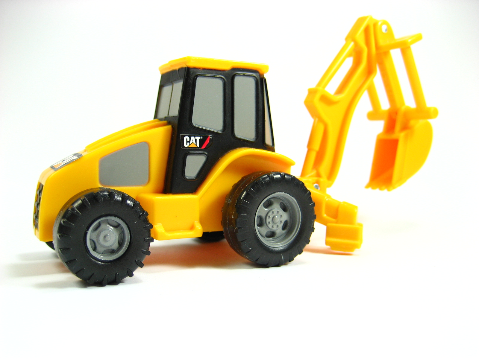 a toy tractor is on a white surface