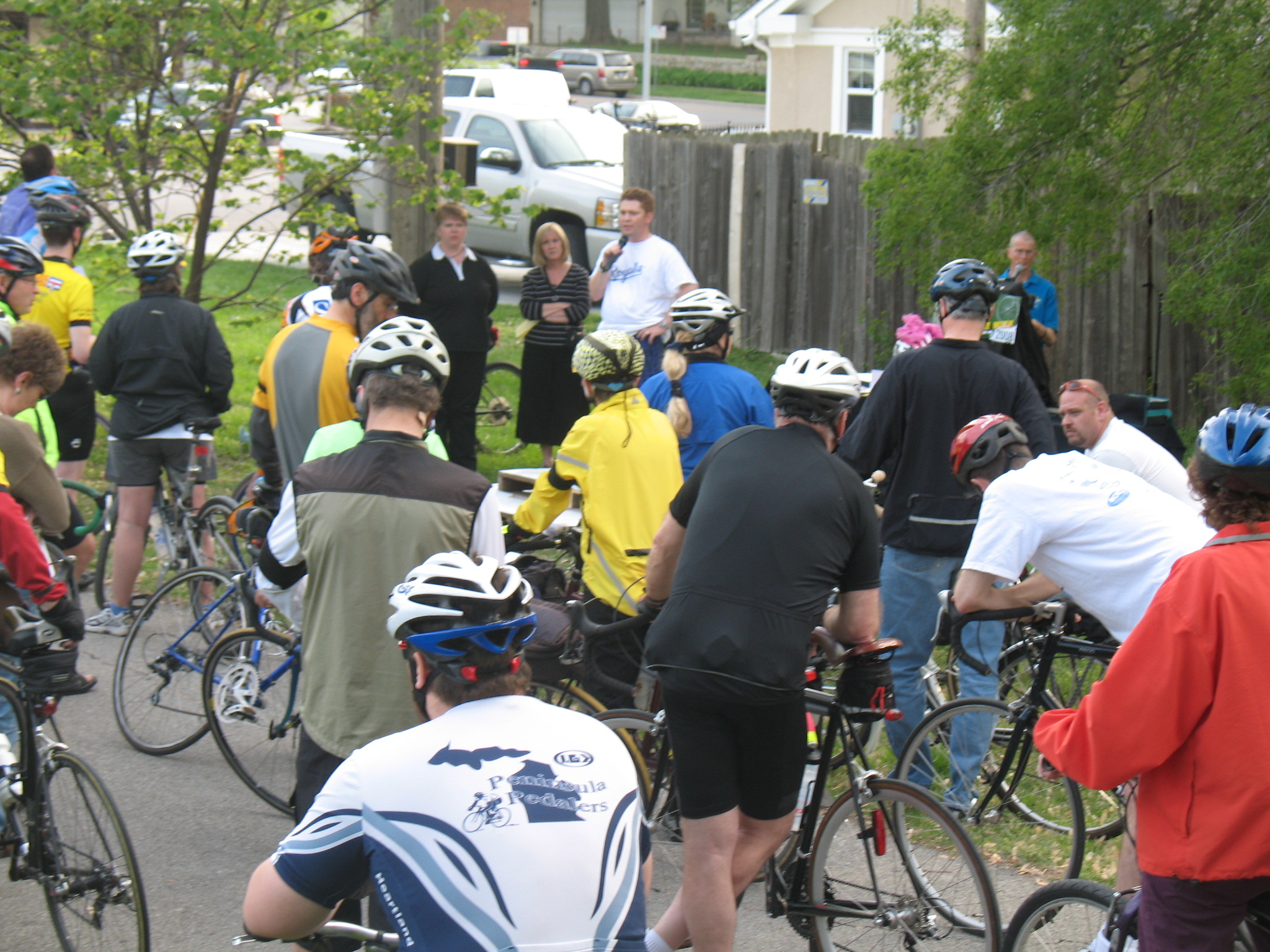 a large group of people riding bikes down the street