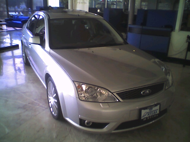 a grey car is shown in a garage