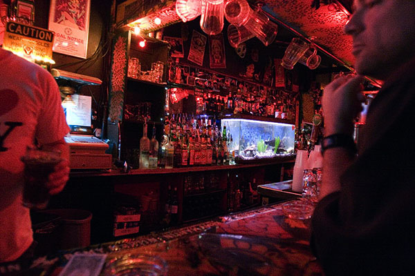 two men sitting at a bar in a restaurant