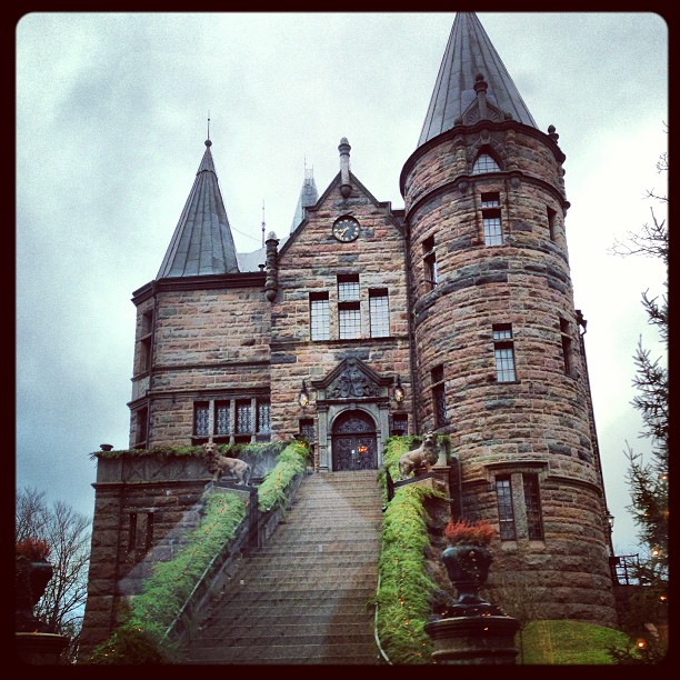 a very big pretty castle with some stairs and railings