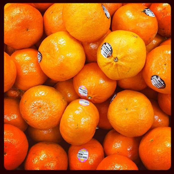 a bunch of oranges with a stripe painted on them